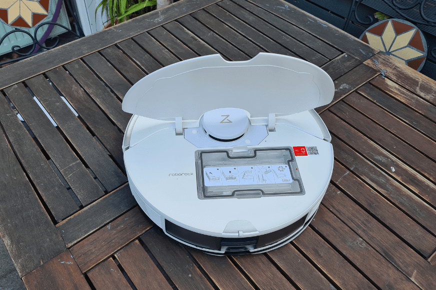 The Roborock S7 Pro Ultra vacuum robot stands on the table with an open flap.